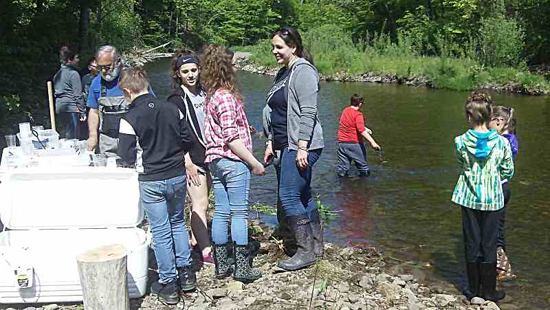 students stocking fish